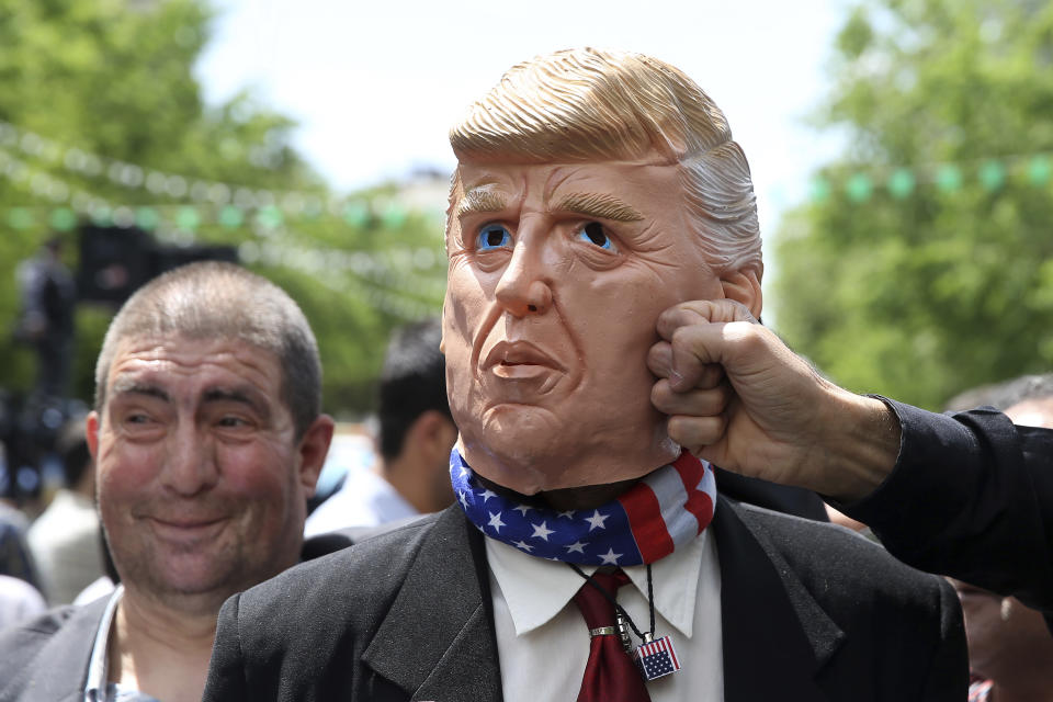 An Iranian protester pretends to punch a mask mocking President Donald Trump during a rally after Friday prayer in Tehran, Iran, Friday, May 10, 2019. A top commander in Iran's powerful Revolutionary Guard said Friday that Tehran will not talk with the United States, an Iranian news agency reported — a day after President Donald Trump said he'd like Iranian leaders to "call me." (AP Photo/Ebrahim Noroozi)