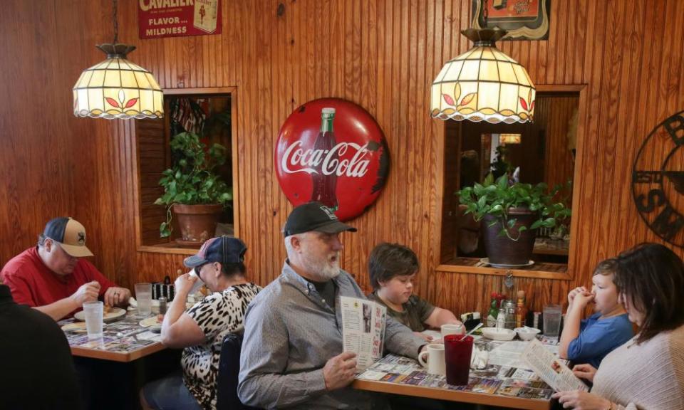 People order breakfast at Bill Smith’s Cafe, after The governor Greg Abbott issued a rollback of Covid restrictions in March,