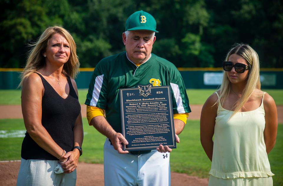 Blackhawk American Legion assistant coach Joe Basil gets emotional during a ceremony in memory of long-time coach Bob Amalia, who died in November 2020 of cancer, before their playoff game against Brighton Township Legion on July 6, 2021. At left is Audrey Amalia, Bob's wife, and their daughter Mackenzie Amalia is at right.