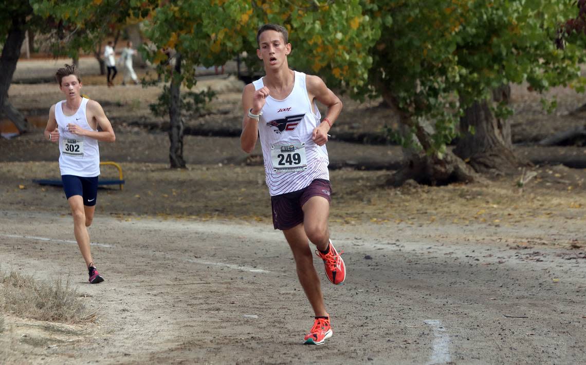 Fresno Christian freshman Blake Bay (1st, 16:11.16) leads Division V runners at the CIF Central Section cross country championships at Woodward Park on Nov. 16, 2023.