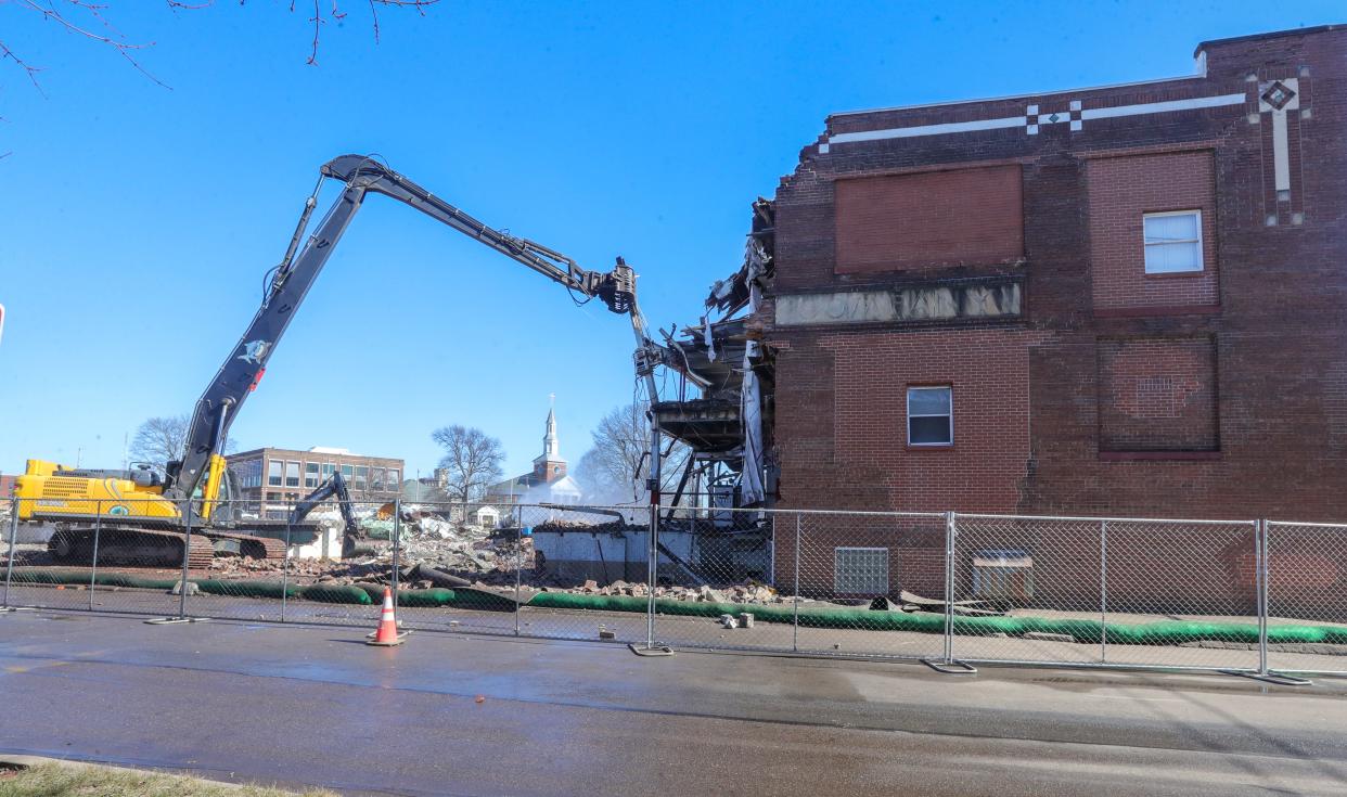 A demolition crew takes down the former Wonder Bread and Continental Baking Co. plant at Forge and Union streets on Tuesday in Akron. The crew has been using John Deere excavators to raze the 60,000-square-foot structure.