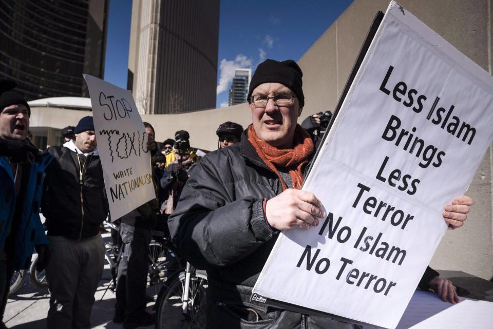 A man carries an anti-Islamic sign.