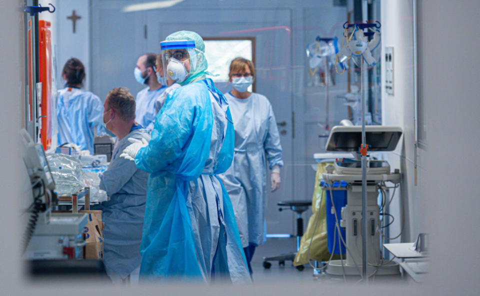 Medical staff wearing protective masks and clothing stand at the intensive care unit at the St. Josef Hospital on Wednesday in Bochum, Germany. Source: Getty