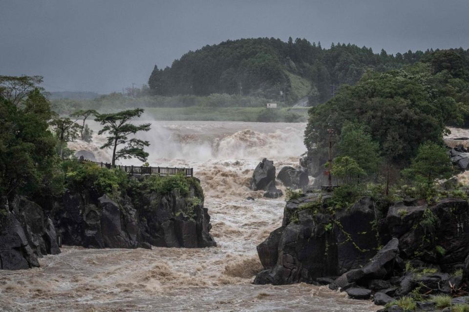 Raging waters flow along the Sendai River in the wake of Typhoon Nanmadol in Isa, Kagoshima prefecture on Monday (AFP via Getty Images)