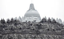 Borobudur temple is partially covered with plastic sheets to protect from volcanic ash, from an eruption of Mount Kelud, in Magelang, central Java, Indonesia, Friday, Feb. 14, 2014. An explosive volcanic eruption on Indonesia's most populous island blasted ash and debris 18 kilometers (12 miles) into the air Friday, killing two people while forcing authorities to evacuate more than 100,000 and close six airports. (AP Photo/Slamet Riyadi)