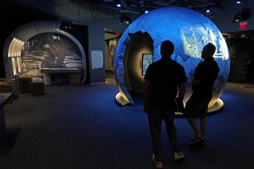 People view an exhibit on the Cold War during a tour of the Harry S. Truman Presidential Library and Museum Wednesday, June 9, 2021, in Independence, Mo. The facility will reopen July 2 after a nearly $30 million renovation project. (AP Photo/Charlie Riedel)