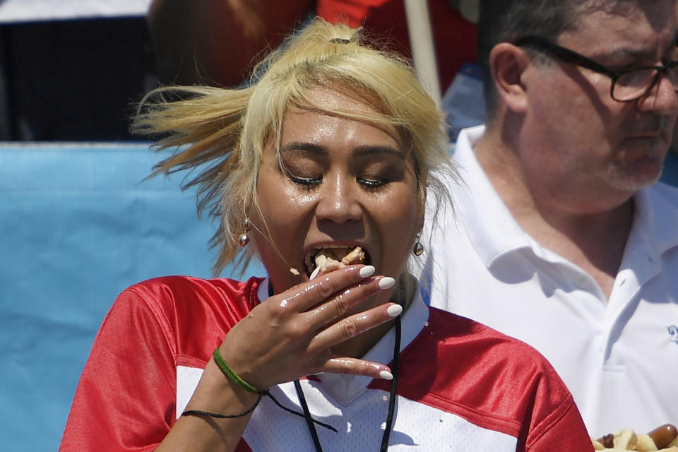 Miki Sudo consumes hot dogs during the women's competition of Nathan's Famous July Fourth hot dog eating contest, Thursday, July 4, 2019, in New York's Coney Island. (AP Photo/Sarah Stier)