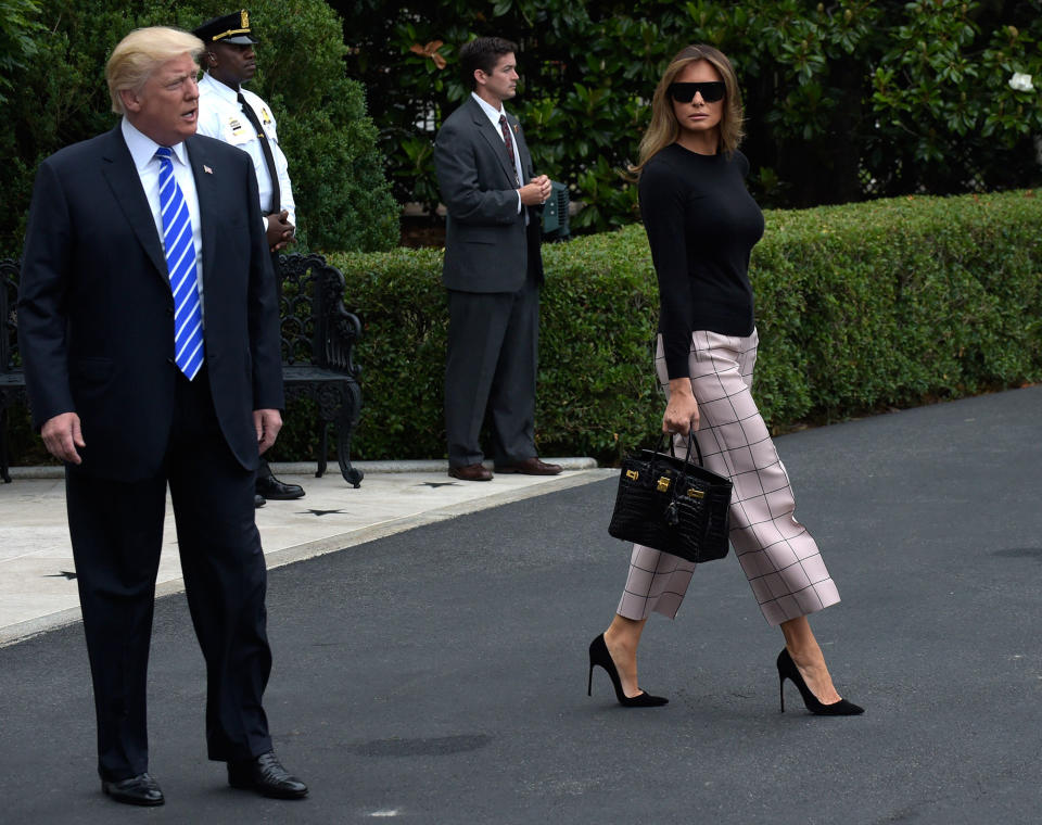 <p>President Donald Trump stops briefly in front of reporters as he and first lady Melania Trump walk to Marine One on the South Lawn of the White House in Washington, Wednesday, July 5, 2017. The Trumps are heading to Poland and then Germany for the G20. (Photo: Susan Walsh/AP) </p>