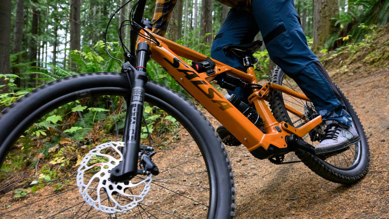  Salsa Cycles Moraine e-mtb being ridden through the woods. 