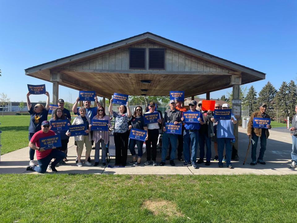 Members of the AFGE Local 1509, representing Sioux Falls VA hospital workers, and veterans stand for a photo during a protest against the recommended closure of the Sioux Falls VA hospital emergency room.