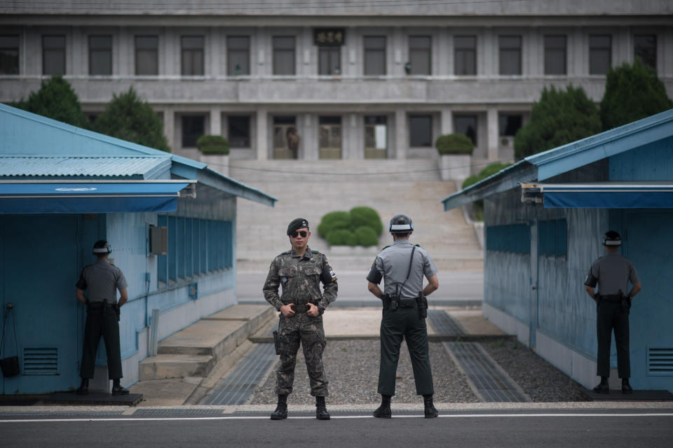 In a photo taken on August 2, 2017 South Korean soldiers stand guard before North Korea's Panmon Hall (rear C) and the military demarcation line separating North and South Korea, at Panmunjom, in the Joint Security Area (JSA) of the Demilitarized Zone (DMZ).  / Credit: Ed Jones / AFP/Getty Images