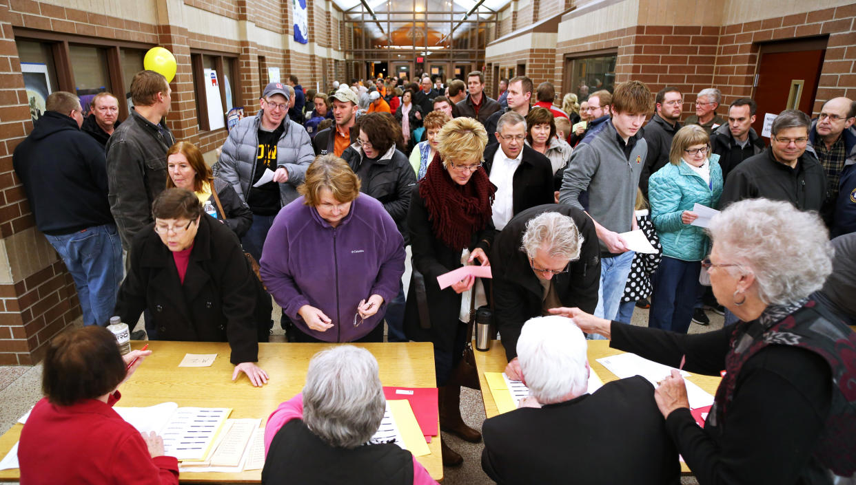 Republican voters register before taking part in caucuses in Carroll, Iowa (Jeff Storjohann / Carroll Daily Times Herald via AP file)