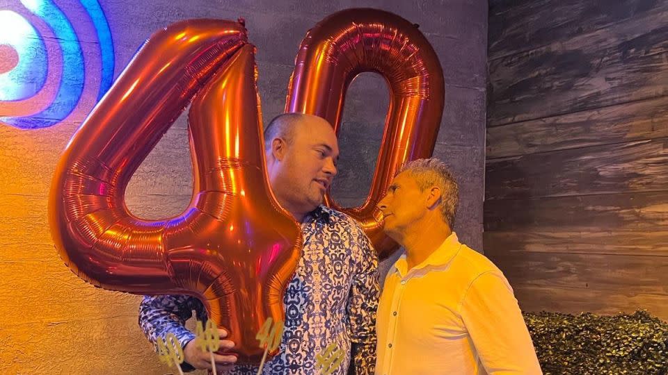 This photo from Brian Butler's 40th birthday party shows Butler, left, and Carlos De Oliveira, right. - Obtained by CNN