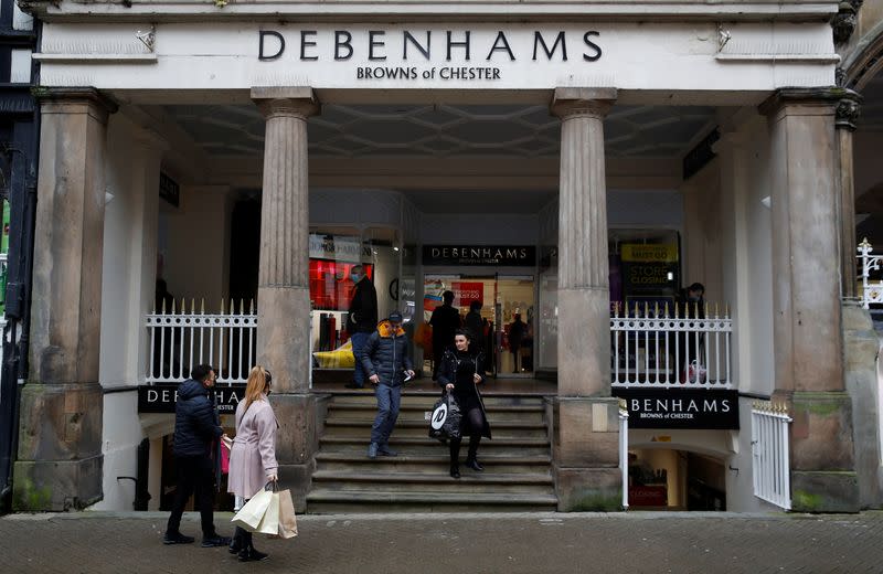 Shoppers walk out of a Debenhams store in Chester, Britain