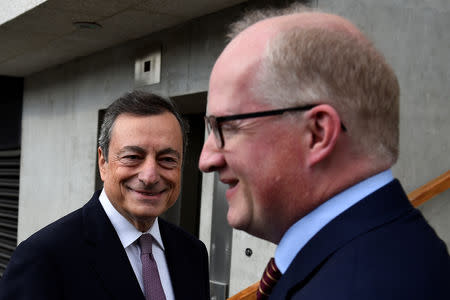 FILE PHOTO: President of the European Central Bank Mario Draghi greets Governor of the Central Bank of Ireland Philip Lane at Trinity College in Dublin, Ireland September 22, 2017. REUTERS/Clodagh Kilcoyne/File Photo