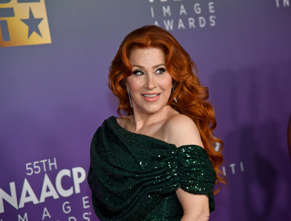 Lisa Ann Walter in a green gown posing at the NAACP Image Awards