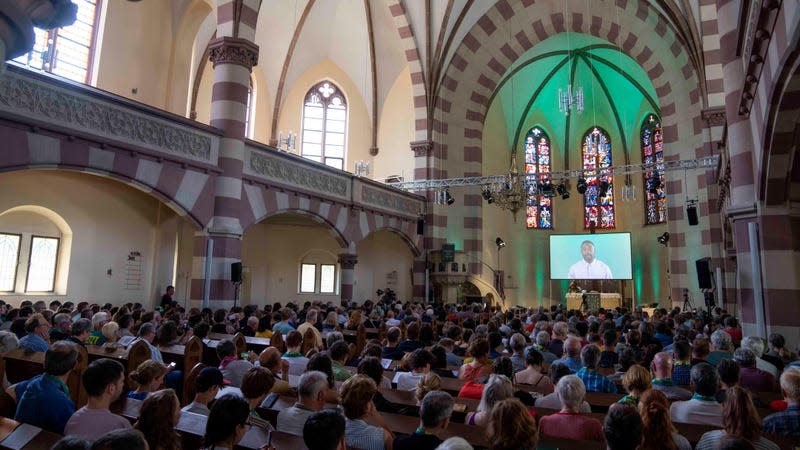 People attend a church service in Nuremberg, Germany, Friday, June 9, 2023. Hundreds of German Protestants have attended a church service in Bavaria that was generated almost entirely by artificial intelligence. 