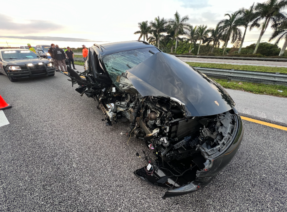 A Porsche with heavy damage to its front right side is parked on I-75 in Weston Tuesday, Jan. 2, 2024.