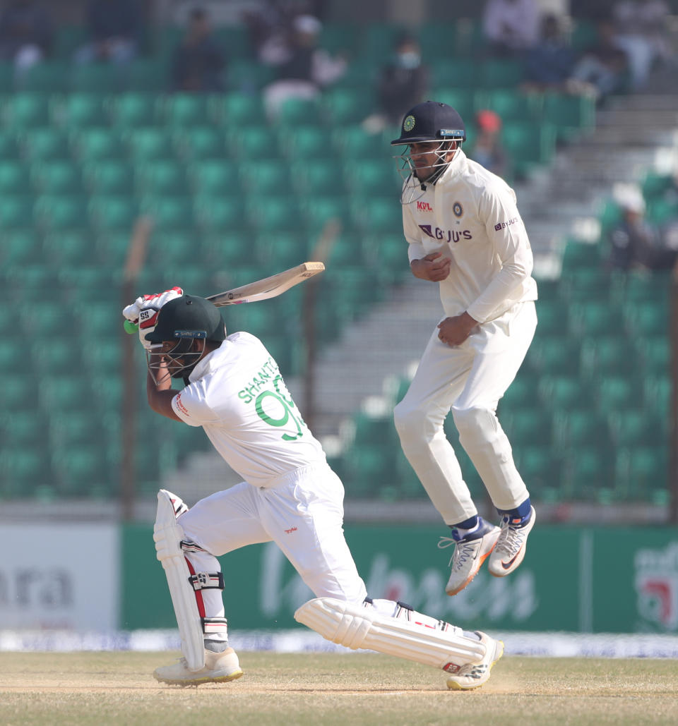 Bangladesh's Najmul Hossain Shanto, left, plays a shot as India's Shubman Gill jumps to save himself during the first Test cricket match on day four between Bangladesh and India in Chattogram Bangladesh, Saturday, Dec. 17, 2022. (AP Photo/Surjeet Yadav)