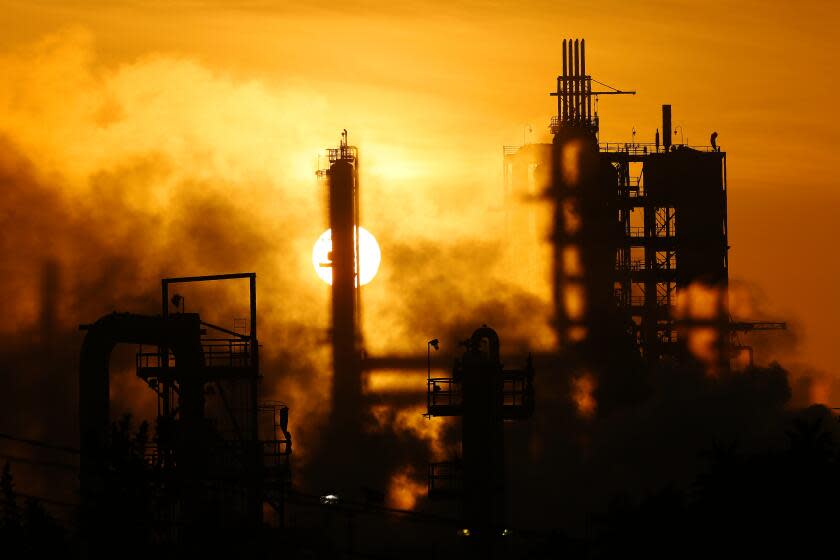 WILMINGTON, CA -- TUESDAY, MARCH 1, 2016 -- The Phillips 66 refinery looms over a Wilmington neighborhood where some long-time residents feel their health issues might stem from their proximity to the refinery. The Union Oil Company of California built the original refinery in 1919 between the old Anaheim road and the port, years before homes were constructed to form the neighborhood. ( Rick Loomis / Los Angeles Times )