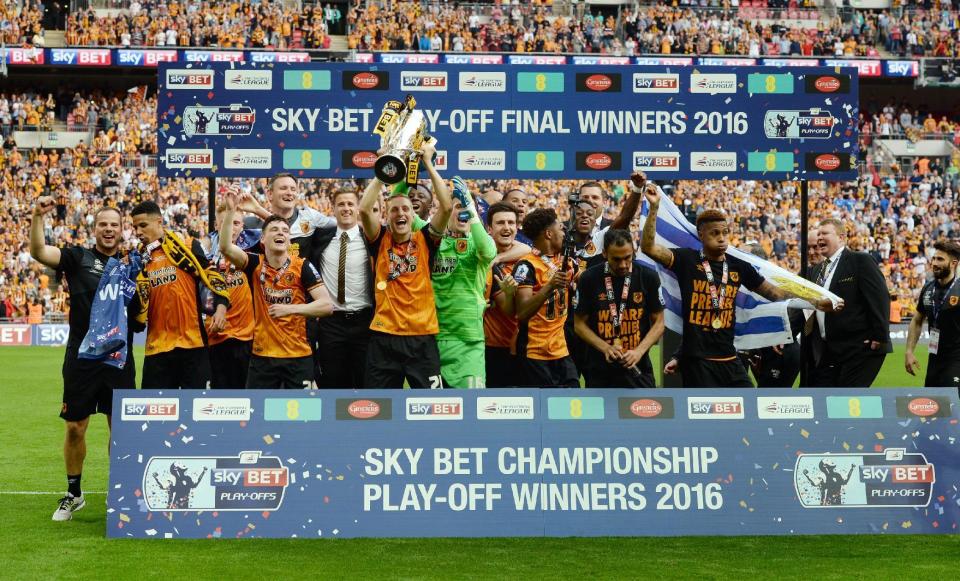 Britain Soccer Football - Hull City v Sheffield Wednesday - Sky Bet Football League Championship Play-Off Final - Wembley Stadium - 28/5/16 Hull City's Michael Dawson lifts the trophy as they celebrate winning promotion back to the Premier League Action Images via Reuters / Tony O'Brien Livepic EDITORIAL USE ONLY. No use with unauthorized audio, video, data, fixture lists, club/league logos or "live" services. Online in-match use limited to 45 images, no video emulation. No use in betting, games or single club/league/player publications. Please contact your account representative for further details.