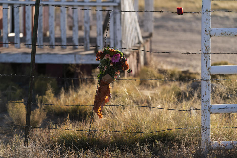 A bouquet of flowers is left to honor cinematographer Halyna Hutchins outside the Bonanza Creek Ranch in Santa Fe, N.M., Sunday, Oct. 24, 2021. Hutchins died after actor Alec Baldwin fired a fatal gunshot from a prop gun that he had been told was safe. (AP Photo/Jae C. Hong)