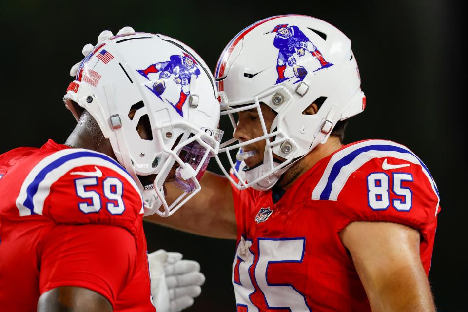 New England Patriots tight end Hunter Henry (85) celebrates with offensive tackle Vederian Lowe (59) after a touchdown during the second half of an NFL football game Miami Dolphins on Sunday, Sept. 17, 2023, in Foxborough, Mass. (AP Photo/Greg M. Cooper) ORG XMIT: NYOTK