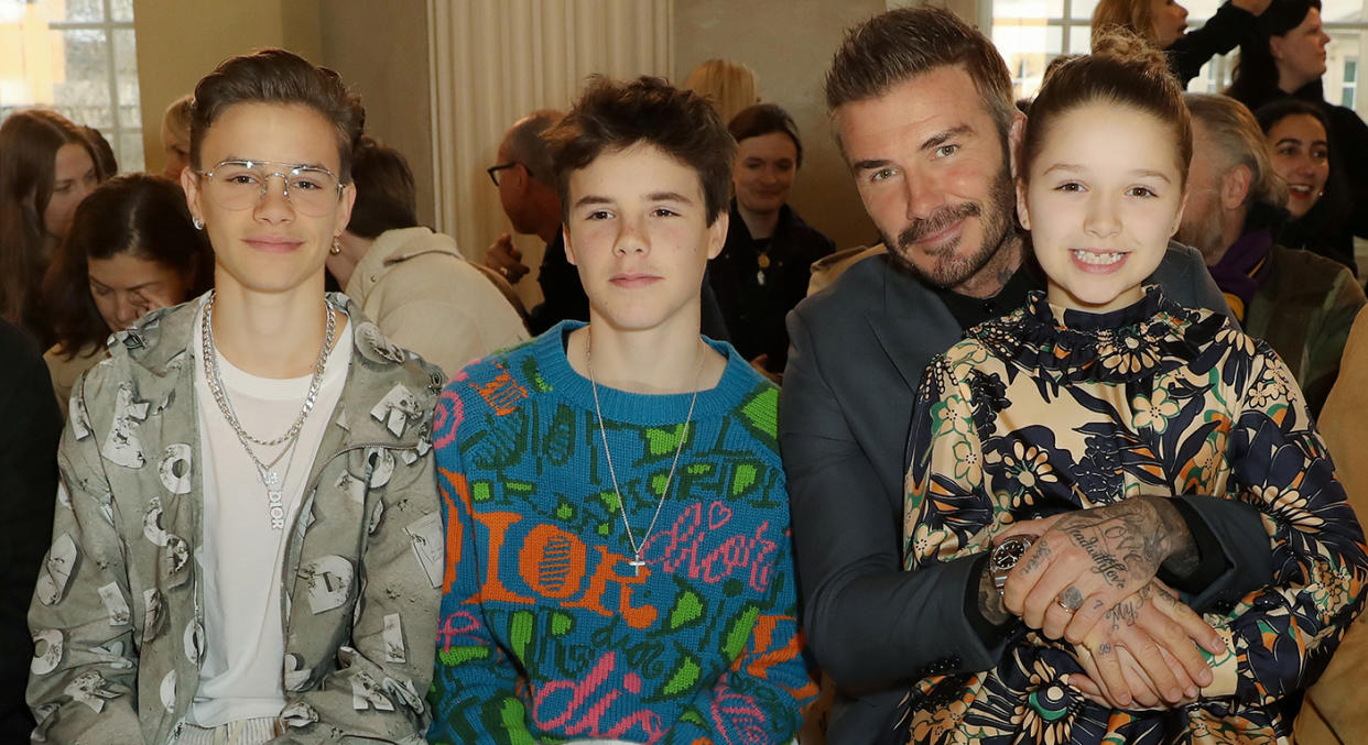 Harper Beckham dishes more style inspiration in NHS t-shirt and Adidas sliders.  (Getty Images)