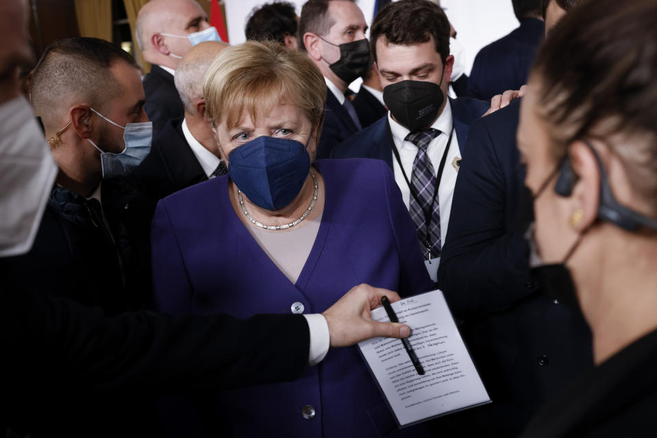 German Chancellor Angela Merkel leaves after a conference on Libya in Paris Friday, Nov. 12, 2021. France is hosting an international conference on Libya on Friday as the North African country is heading into long-awaited elections next month. (Yoan Valat/Pool Photo via AP)