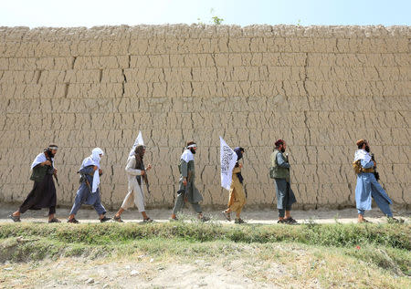 Taliban walk as they celebrate ceasefire in Ghanikhel district of Nangarhar province, Afghanistan June 16, 2018.REUTERS/Parwiz TPX IMAGES OF THE DAY