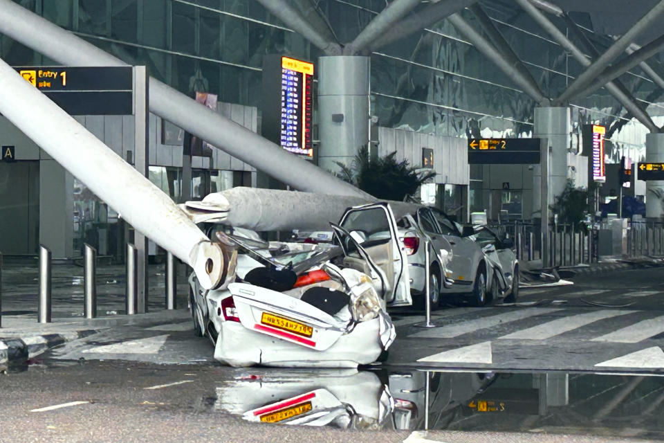 Parked vehicles are damaged by the collapse of a departure terminal canopy at New Delhi's Indira Gandhi International Airport following heavy pre-monsoon rains in New Delhi, India, Friday, June 28, 2024. (AP Photo)