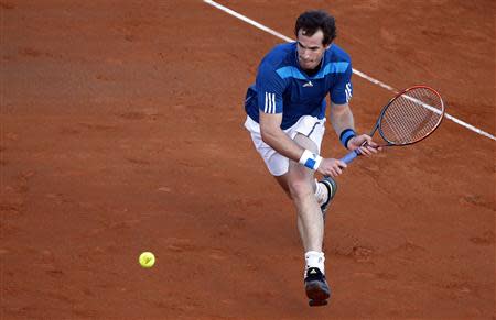 Britain's Andy Murray returns a shot against Italy's Andreas Seppi during their Davis Cup quarter-final tennis match in Naples April 4, 2014. REUTERS/Alessandro Bianchi