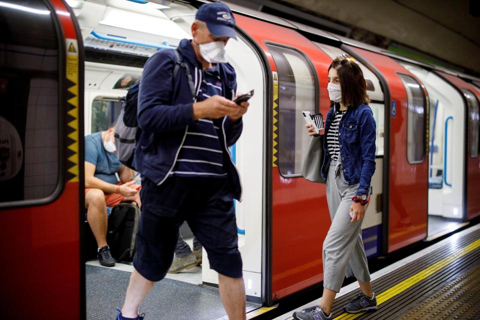 Commuters wearing a face mask travel on TfL Victoria Line underground train carriages, heading towards central London, on June 15, 2020 after new rules make wearing face coverings on public transport compulsory while the UK further eases its coronavirus lockdown. - New coronavirus pandemic rules coming into force on June 15 make wearing face coverings such as masks or scarves compulsory on public transport, as various stores and outdoor attractions open for the first time in nearly three months. (Photo by Tolga AKMEN / AFP) (Photo by TOLGA AKMEN/AFP via Getty Images)