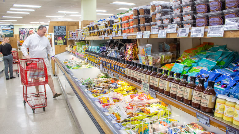 man browsing Trader Joe's freezer