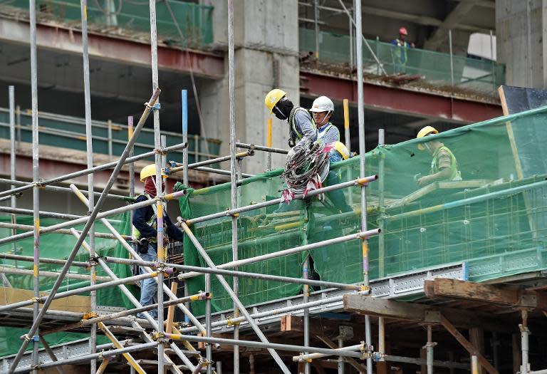 Labourers work at a construction site in Singapore, on August 8, 2014