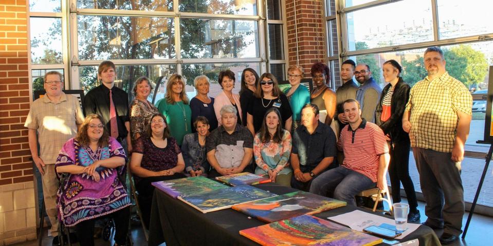 The Classic Charitable Foundation smiles with members from the Arts at Bost after their check presentation from Art on the Border in 2019.