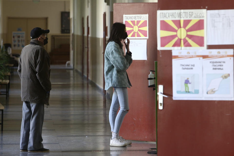 People wait to enter a polling station in Skopje, North Macedonia, on Sunday, Oct. 31, 2021. North Macedonia is holding a runoff of local elections on Sunday seen as key test for the leftist government after center-right opposition has won mayoral posts in 21 municipalities compared with only nine of ruling Social-democrats in the first round of the vote two weeks ago. (AP Photo/Boris Grdanoski)