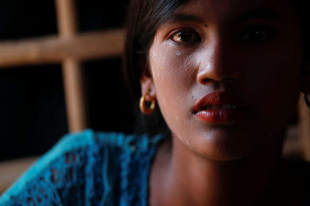 Zi Porbin, a 14-year-old Rohingya orphan, is photographed at her shelter in the camp for widows and orphans inside the Balukhali camp near Cox's Bazar, Bangladesh, December 5, 2017. Zi Porbin, whose mother died of illness two years ago, said she fled Sindi Prang village, Buthidaung township with other Rohingya as it was attacked by Mynamar military three days before Eid al-Adha in September this year. She was told by other villagers that her father was killed in the attack. Zi Porbin and her younger sister now live with their aunt whose husband was also killed the same day, and more than 230 others in the camp for Rohingya widows and orphans. REUTERS/Damir Sagolj