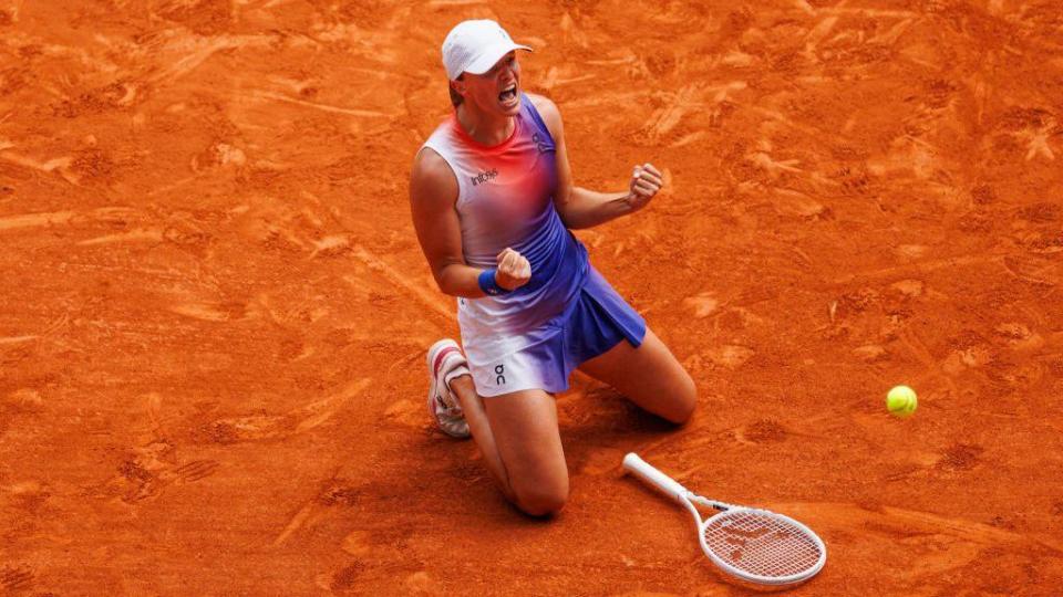 Iga Swiatek drops to the floor as she wins third straight French Open title