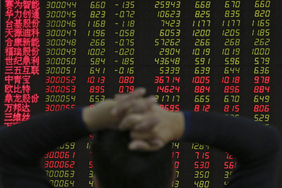 A man monitors shares prices at a brokerage house in Beijing, Tuesday, Jan. 22, 2019. Asian markets were mostly lower on Tuesday after the International Monetary Fund trimmed its global outlook for 2019 and 2020. This came after China said its economy grew at the slowest pace in 30 years. (AP Photo/Andy Wong)