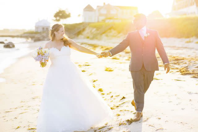 <p>Alex Gordias</p> Sarah Kennedy and husband Jam Sulahry walk on the beach after their wedding ceremony.