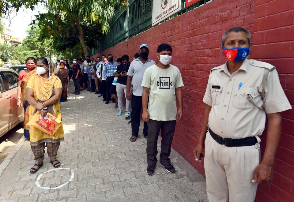 GURUGRAM, INDIA - JUNE 25: Beneficiaries wait to receive COVID-19 vaccine dose, at a vaccination centre in Sector 15, on June 25, 2021 in Gurugram, India. (Photo by Vipin Kumar/ Hindustan Times via Getty Images)