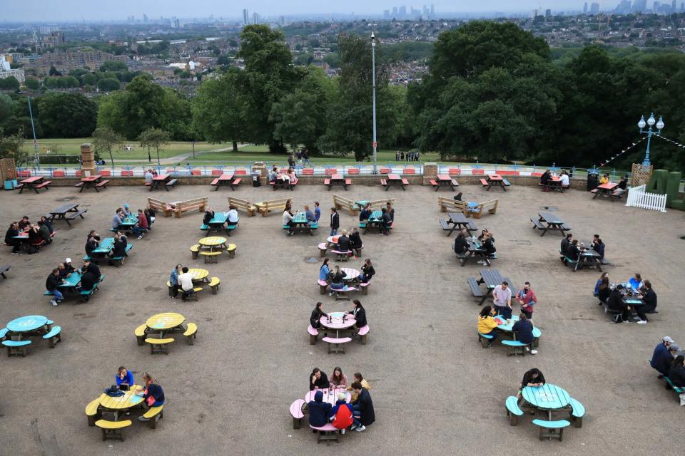 Socially distanced tables are served at The Terrace Bar, Alexandra Palace, London (PA)