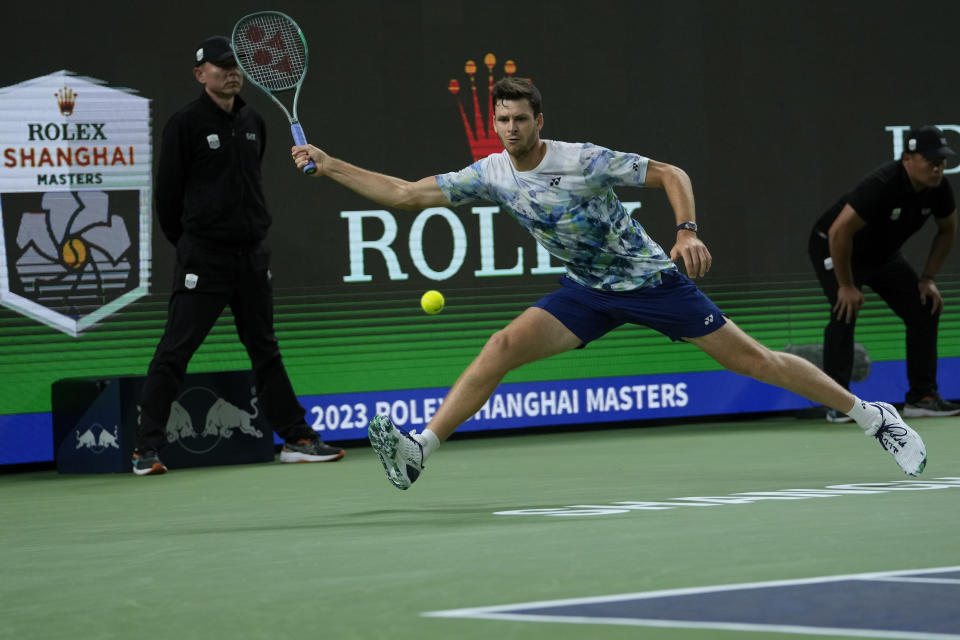 Hubert Hurkacz of Poland reaches for the ball during the men's singles quarterfinal match against Fabian Marozsan of Hungary in the Shanghai Masters tennis tournament at Qizhong Forest Sports City Tennis Center in Shanghai, China, Thursday, Oct. 12, 2023. (AP Photo/Andy Wong)