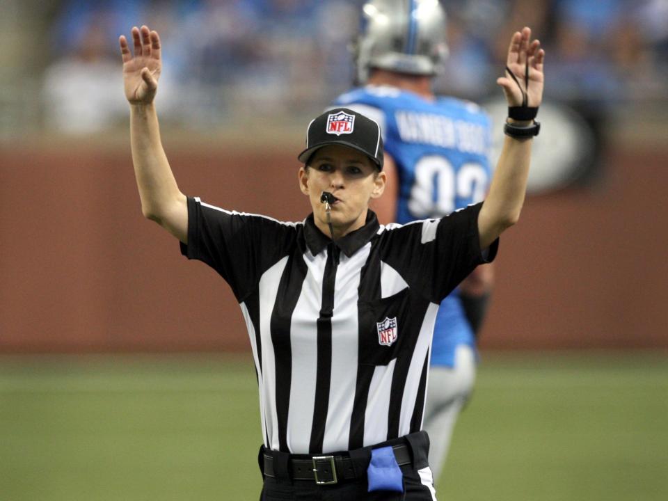 NFL replacement Field Judge Shannon Eastin blows her whistle after throwing a penalty flag during the first half of the NFL football game between the Detroit Lions and St. Louis Rams in Detroit, Michigan September 9, 2012.