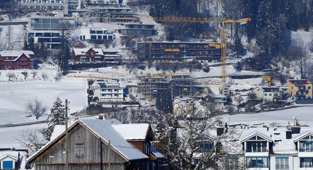 Residential buildings and a construction site of a new one are seen during sunny winter weather on a mountainside in the town of Unteraegeri, Switzerland February 5, 2019. REUTERS/Arnd Wiegmann