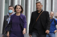 Co-chairwoman of the Greens and candidate for chancellor Annalena Baerbock, left, and co-party leader of the Greens Robert Habeck arrive for a press conference in Berlin, Germany, Monday, Sept. 27, 2021. Following Sunday's election leaders of the German parties were meeting Monday to digest a result that saw Merkel's Union bloc slump to its worst-ever result in a national election and appeared to put the keys to power in the hands of two opposition parties. Both Social Democrat Olaf Scholz and Armin Laschet, the candidate of Merkel's party, laid a claim to leading the next government. (AP Photo/Matthias Schrader)