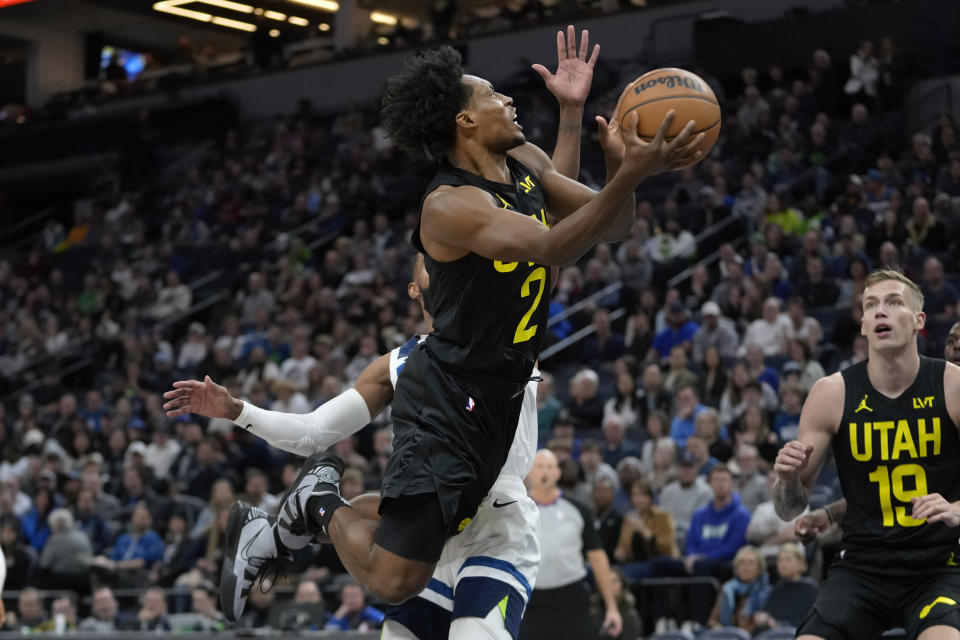 Utah Jazz guard Collin Sexton (2) goes up for a shot as Minnesota Timberwolves guard Mike Conley, back, defends during the first half of an NBA basketball game Thursday, Nov. 30, 2023, in Minneapolis. (AP Photo/Abbie Parr)