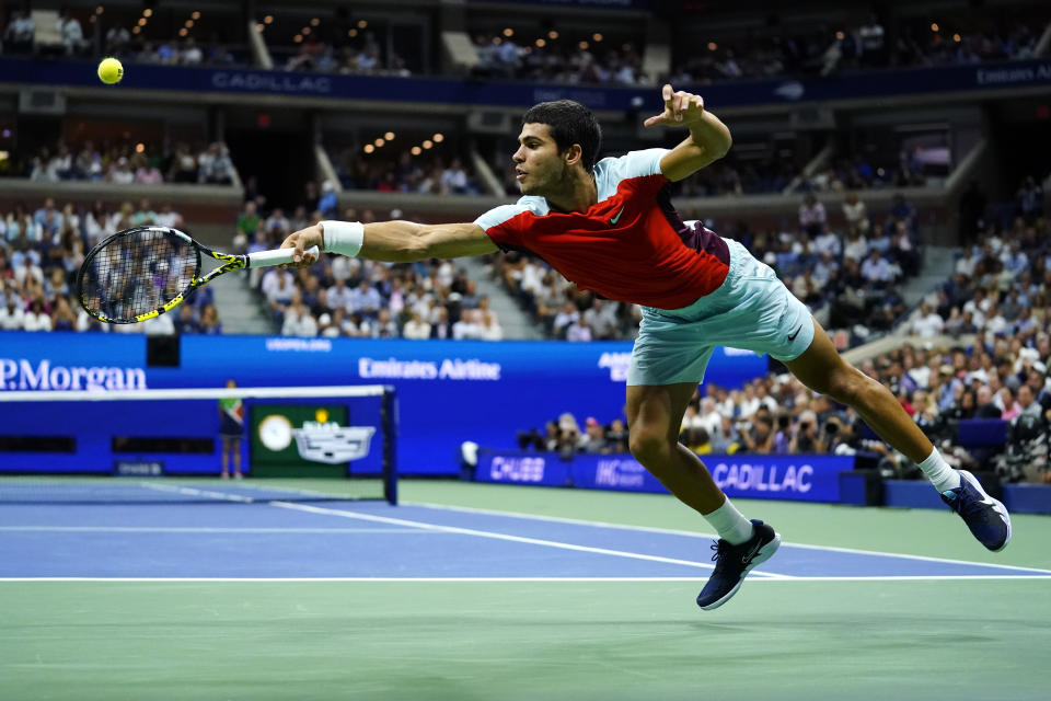 Carlos Alcaraz, of Spain, returns a shot to Frances Tiafoe, of the United States, during the semifinals of the U.S. Open tennis championships, Friday, Sept. 9, 2022, in New York. (AP Photo/Matt Rourke)