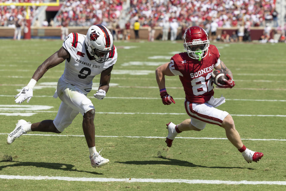 Oklahoma wide receiver Gavin Freeman (82) carries past Arkansas State safety Trevian Thomas (9) during the first half of an NCAA college football game, Saturday, Sept. 2, 2023, in Norman, Okla. (AP Photo/Alonzo Adams)